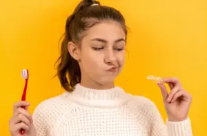 Young Teenager Holding Toothbrush